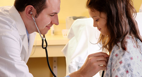 Doctor using a stethoscope on a patient