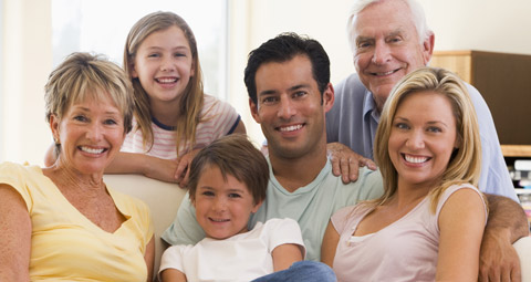 A family in a huddle, smiling to the camera